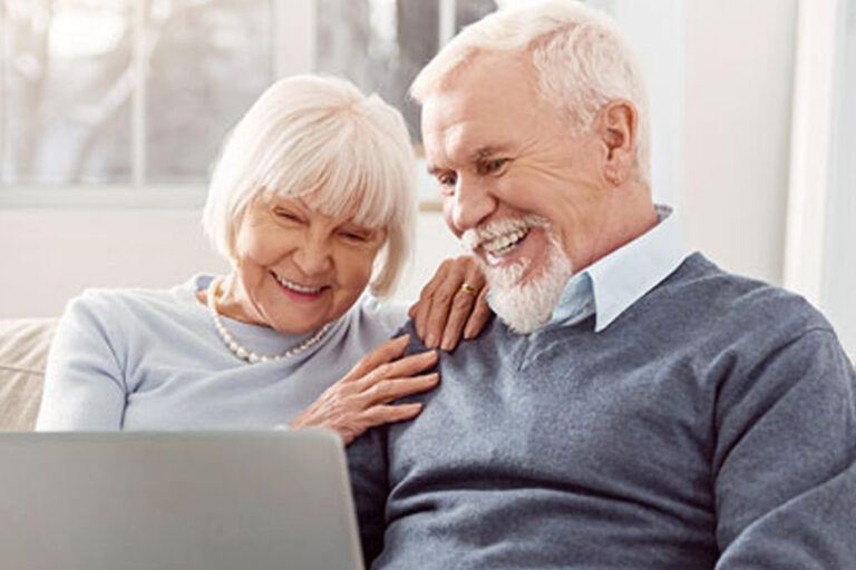 Couple smiling sitting on sofa